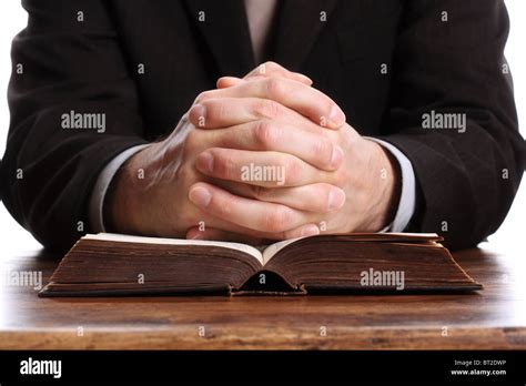 Praying Hands On An Open Bible Stock Photo Alamy