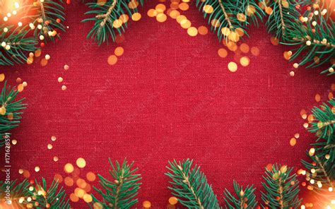 Christmas Background With Xmas Tree And Sparkle Bokeh Lights On Red