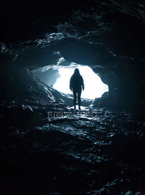 Silhouette Of Unrecognizable Person Standing At Cave Entrance — Ground