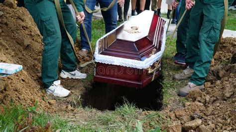 Burial Men Lower The Coffin Into The Grave N Stock Image Image Of