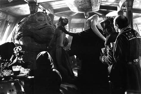 slave leia in jabba s embrace as bib forces the enslaved princess against her master while
