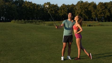 Guy And A Girl Make Selfie On The Golf Course Stock Footage Videohive