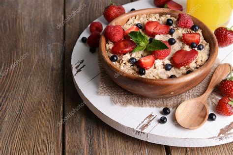 Tasty Oatmeal With Berries On Table Close Up — Stock Photo © Belchonock