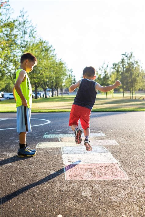 Asian Kids Playing Hopscotch In The Playground by Take A ...