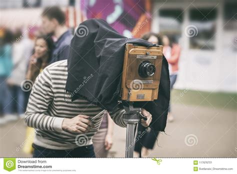Photographer With Antiquity Vintage Wooden Camera Under Dark Cloth Cape Photographing Passers ...