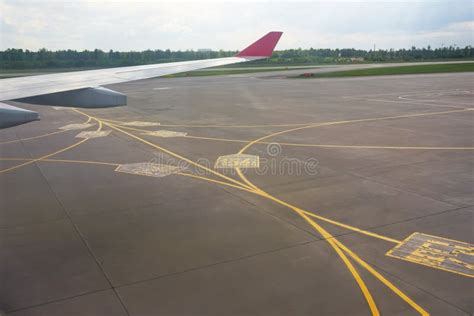 Airport Yellow Taxiway Lines Markings On The Apron On Concrete Asphalt