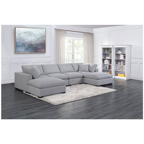 It's covered in a grey fabric, and paired with accent pillows. Thomasville Fabric Modular Sectional 8pc | Costco Australia