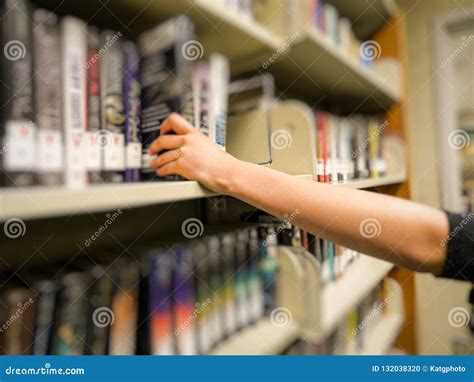 Hand Reaching Out Taking A Book In The Library Stock Photo Image Of