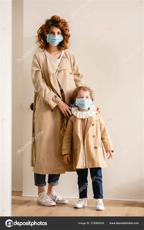 Curly Mother Cute Babe Medical Masks Standing Trench Coats Stock Photo AndrewLozovyi