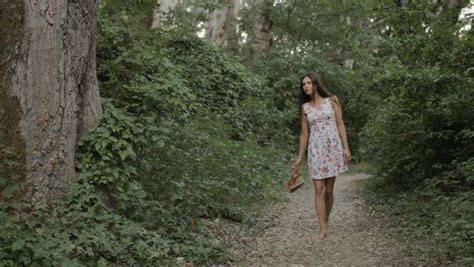 Beautiful Woman Barefoot In The Dress Walking Along A Path In The Woods