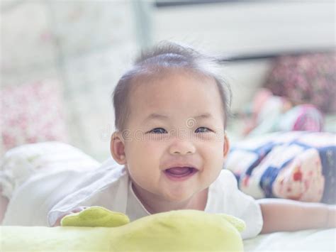 Infant Baby Lying Down On The Bed And Smiling Stock Photo Image Of