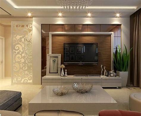 The design is such that it looks like the curvy wooden open shelve is directing all eyes towards the hero of the space the tv. Home LED Unit Design Ideas #bedroom #residence #lobby # ...