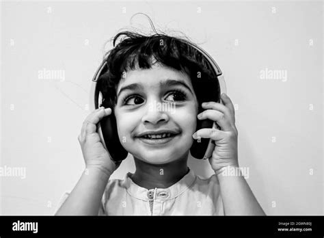 Portrait Of Happy Boy Holding Headphones Stock Photo Alamy