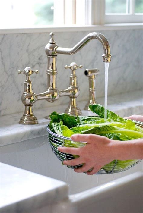 Traditionally, a farmhouse sink was used to hold larger amounts of water. brass bridge faucet with farmhouse sink- WANT | Kitchen ...