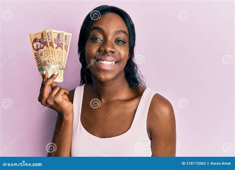Young African American Woman Holding Hungarian Forint Banknotes Looking