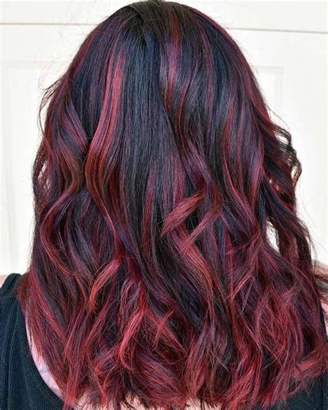 This instagrammer coloured the top section of her hair with a fiery red hue while leaving the underneath section a deep dark hue. 23 Ways to Rock Black Hair with Red Highlights | StayGlam