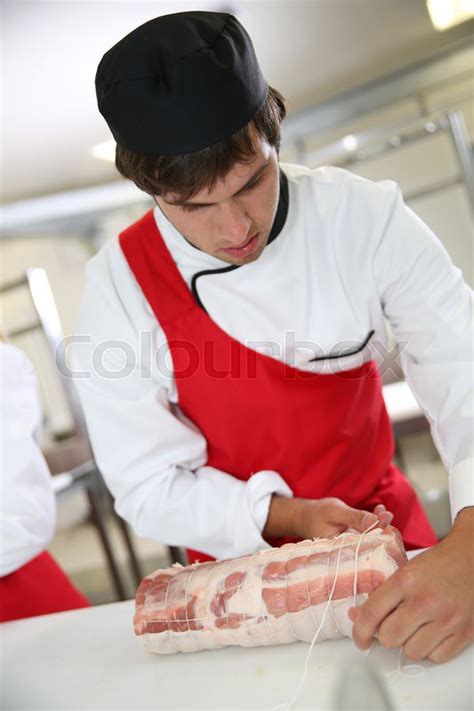 Butcher Preparing Roast In Butchery Stock Image Colourbox