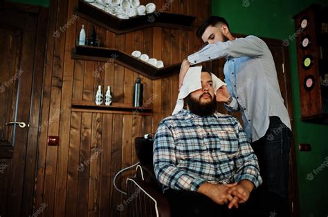 free photo handsome bearded man at the barbershop barber at work washing head