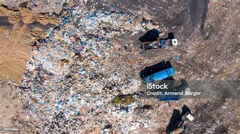 High Angle Shot Of Garbage Trucks At A Landfill Stock Photo Download