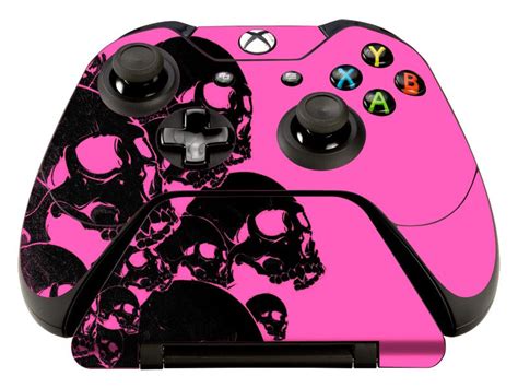 A Pink And Black Controller With Skulls On It
