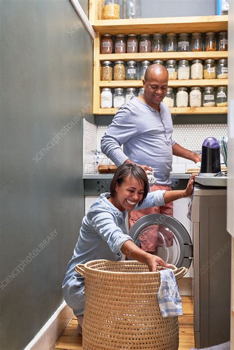 Happy Couple Doing Laundry In Kitchen Stock Image F0311600