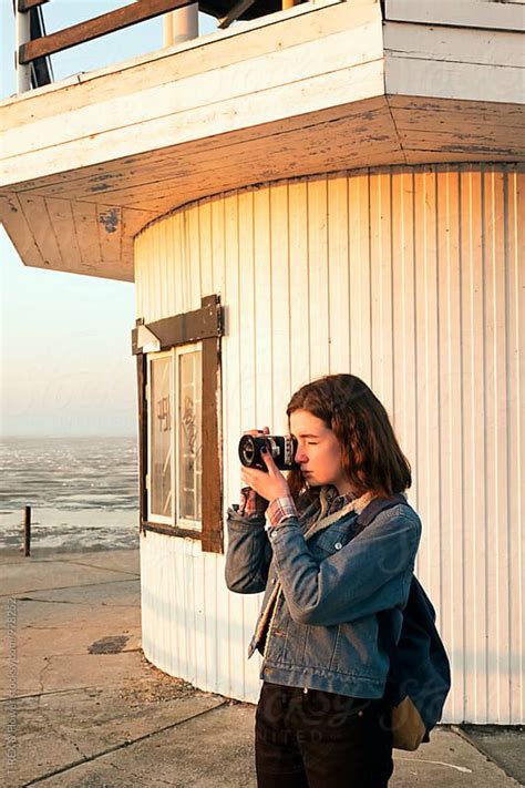 girl taking photograph in morning by stocksy contributor danil nevsky photographer