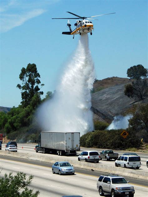 LA County Fire Copter 15 helping to put out a fire along a freeway