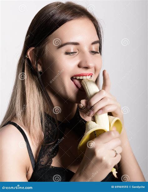 Young Amazed Woman In Lacy Lingerie Holding A Banana She Is Going To Eat A Banana She Sucks A