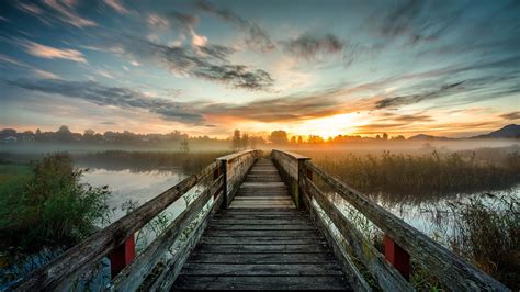 Wooden Bridge And Lake Under Blue Sky With Clouds During Sunset 4k Hd