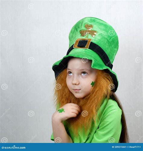 Saint Patricks Day Holiday Portrait Of Adorable Pensive Girl With Clover Leaf On Her Cheek And