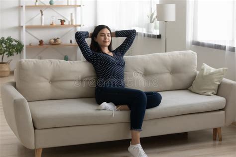 Satisfied Asian Woman Relaxing Stretching On Couch At Home Stock Image Image Of Break Dreamy