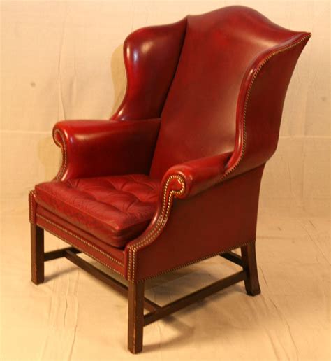 Brass nail head detailing on the curvaceous arms, sides and apron. Single Wing Back Red Leather Chair at 1stdibs