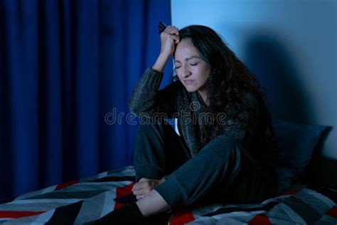 Depressed Woman Sitting Up In Bed Unable To Sleep From Insomnia Stock