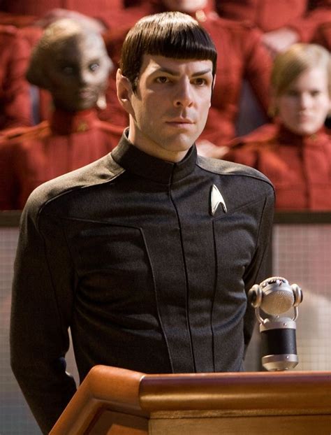 A Man Standing Behind A Podium Wearing A Star Trek Uniform