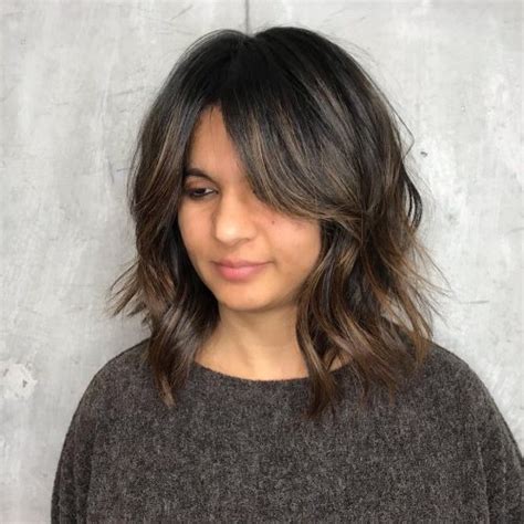 A straight middle parting and longer flipped ends make this fringe an iconic sample of curtain bangs styling. 17 Flattering Medium Hairstyles for Round Faces in 2020