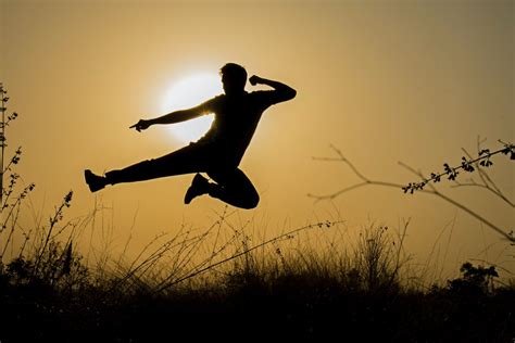 Silhouette Of Man Doing Kick Jump During Sunset · Free Stock Photo