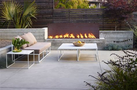 Archaic And Yet With A Modern Touch Outdoor Fireplace With Corten Steel Concrete And Wooden