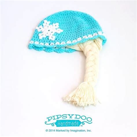 A Crocheted Hat With Snowflakes On It