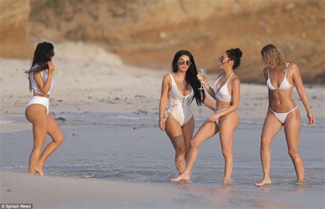 kim kardashian shows off her impressive assets in wet shirt as she frolics on beach in mexico