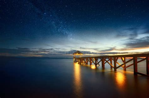 Pier Stretching Out Into The Tranquil Sea At Sunset Stock Image Image