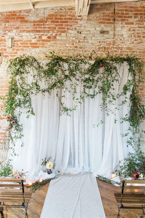 White Draped Wedding Ceremony Backdrop With Greenery Arielle Peters