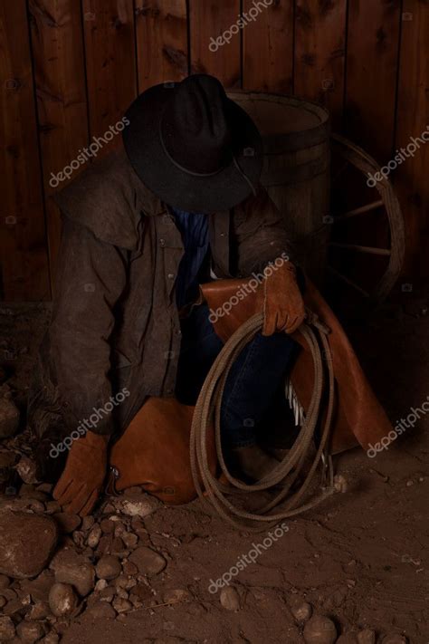 Cowboy Kneeling By Barrel Head Way Down — Stock Photo © Alanpoulson