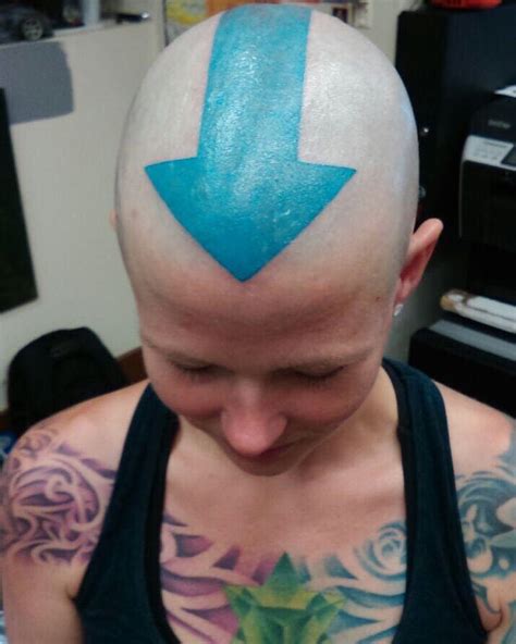 A Bald Man With A Blue Arrow On His Head