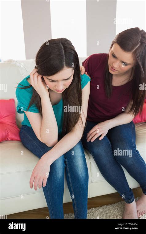 Girl Comforting Her Upset Crying Friend On The Couch Stock Photo Alamy
