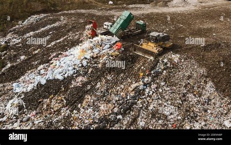 Top Drone View Of Dump With Different Types Of Garbage Trucks
