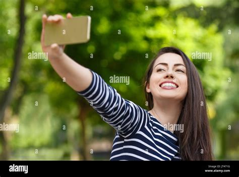Beautiful Young Smiling Woman Taking Selfie Photos With Smartphone Outdoors In Park Summer