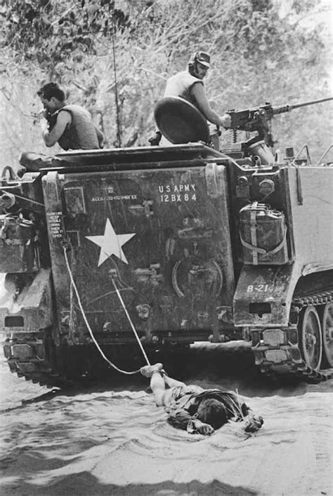 The Body Of A Viet Cong Soldier Is Dragged Behind An American Armored