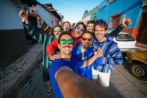 Group Of Happy Friends Taking A Selfie In A Colourful Street On Their