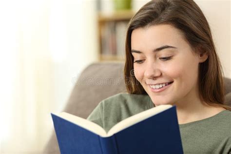 Teen Reading A Paper Book Sitting On A Couch Stock Photo Image Of