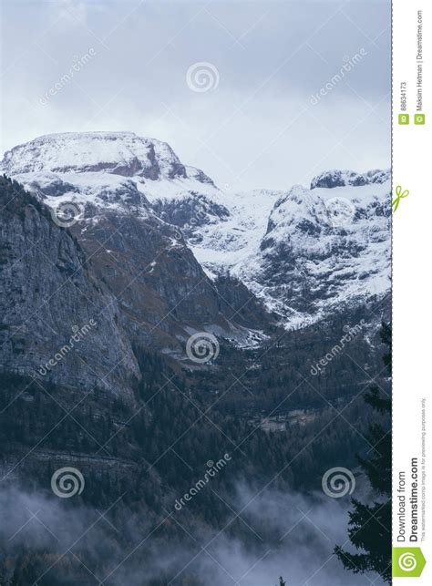 Mountain Top View In The Snow With Fog Italian Alps